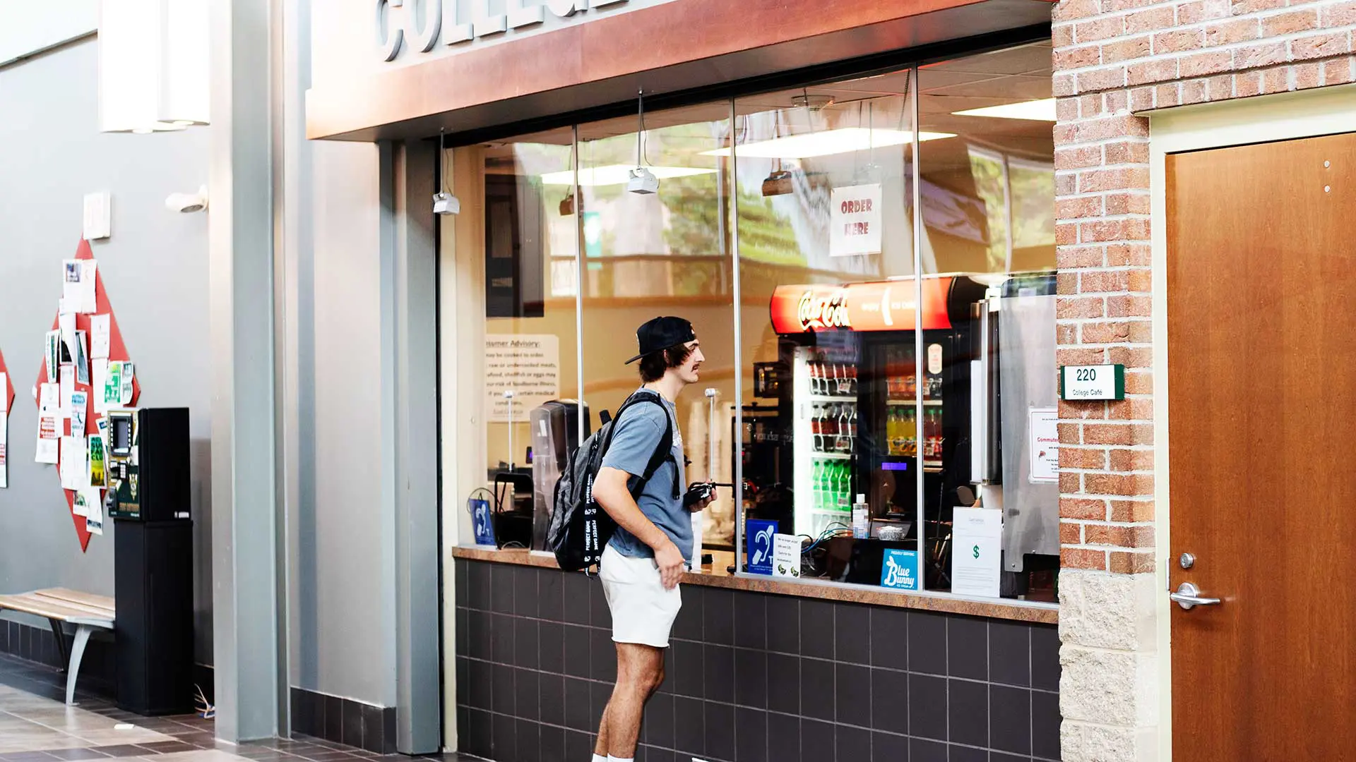 Student waiting to order at cafe window